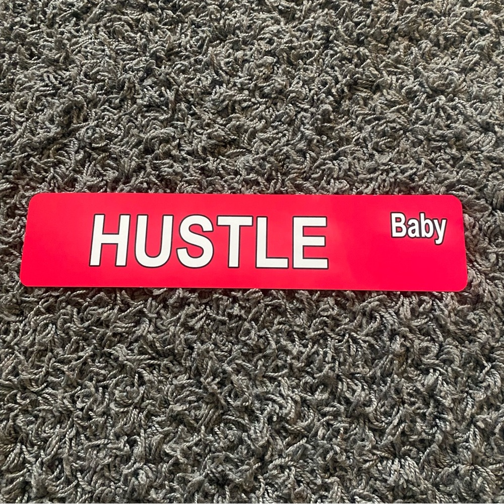 Hustle Baby metal sign